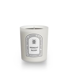 A tall, round, white candle with a dark brown wax. The candle is scented with a midnight bloom fragrance.