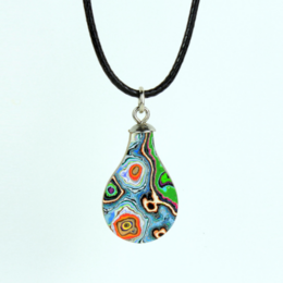 Colorful, abstract pendant necklace with a teardrop shape. Features a vibrant, patterned design in shades of blue, green, red, and yellow. Made of glass or resin material. Hangs from a black cord or leather strap.