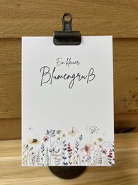 A postcard with a floral design and the text "Blooming blessings" written on it.