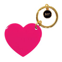 A pink heart-shaped keychain with a gold metal ring and a black circular charm that says "BFF".