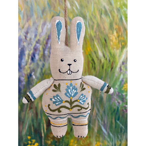 Bunny with paws with blue flowers