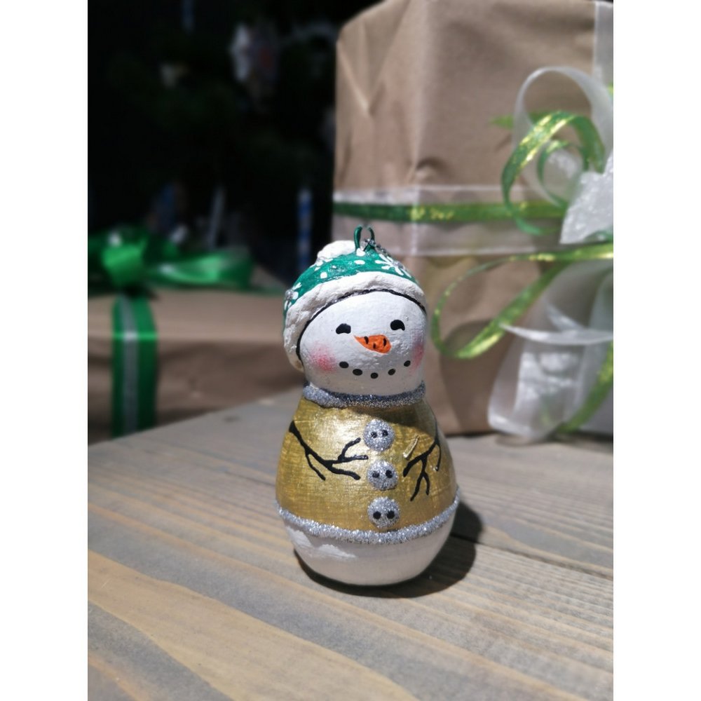 Handmade papier-mache Snowman in a green hat
