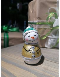 Handmade papier-mache Snowman in a green hat