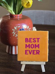 Decorative wall tile with the text "Oh happy day 02" in a blue box, surrounded by three tall white candles.