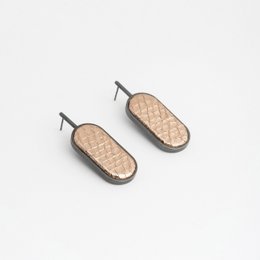 Oval minimalist drop earrings with embossed metallic leather in warm pink and gold colors.