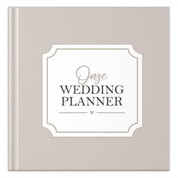  A sand-colored wedding planner notebook with a simple, elegant design featuring the title "One Wedding Planner" in a cursive font.