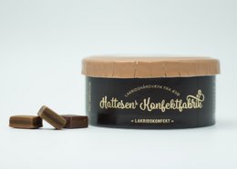 A brown box containing dark chocolate licorice pieces. The box has a simple, minimalist design with the brand name "Chateau d'Orquevaux" prominently displayed.