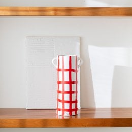 Handpainted Verona vase with a red and white checkered pattern, cylindrical shape, glass material.