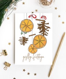 Festive Christmas card with orange slices, pine branches, and the text "Gently Falling". The card features a simple, minimalist design with natural elements, making it suitable for a variety of holiday greetings.