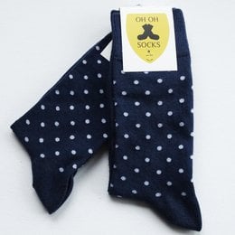 Navy blue socks with white polka dots, suitable for casual or formal wear.