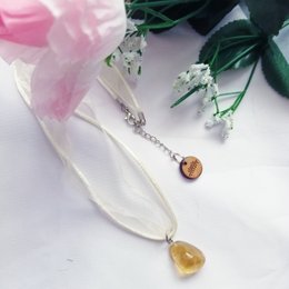 Raw citrine nugget pendant necklace with silver chain. Citrine is a yellow gemstone with a natural, unpolished appearance.