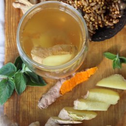 Organic ginger turmeric lemon tea with sliced ginger, turmeric, and lemon. Herbal tea with warm, earthy, and citrusy flavors.