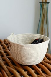 Round, cotton storage basket in a neutral color.