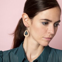 Petrol blue teardrop-shaped earrings with a wooden frame.