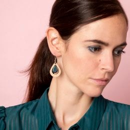 Petrol blue teardrop-shaped earrings with a wooden frame.