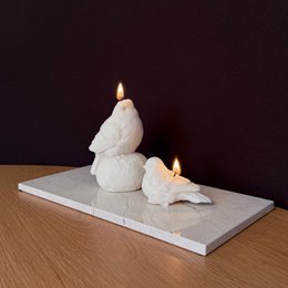 White pillar candles in a minimalist, modern design. Made of wax with a simple, elegant shape.