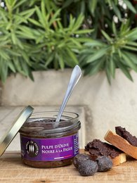 Black olive pulp with fig spread, 90g. Rich, savory spread made with black olives and figs. Ideal for topping bread, crackers, or cheese.