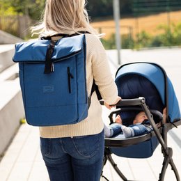 A navy blue backpack-style diaper bag with multiple compartments and a matching stroller. The bag features a sleek, modern design and is suitable for everyday use by parents on the go.