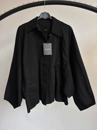 Black oversized button-up shirt jacket, relaxed fit, long sleeves, casual style.