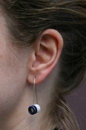 Porcelain ear hangers in blue, green, ochre, and pink colors. Minimalist, cylindrical shape with a circular accent.