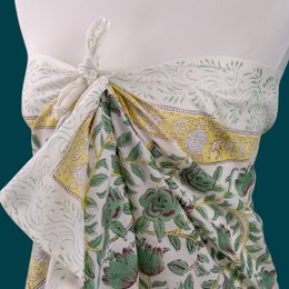  Green and white patterned cotton sarong or beach wrap with floral design, suitable for summer wear.