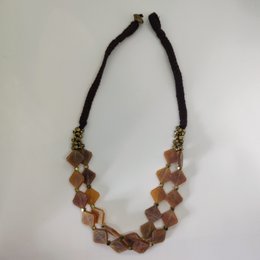 Handcrafted necklace with irregular-shaped brown and gold beads on a dark brown cord.