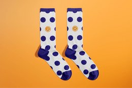 Polka dot patterned socks in orange and blue colors.