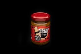 Spicy hot mustard in a glass jar with a red lid. The label features a graphic of a macho man with a mustache.