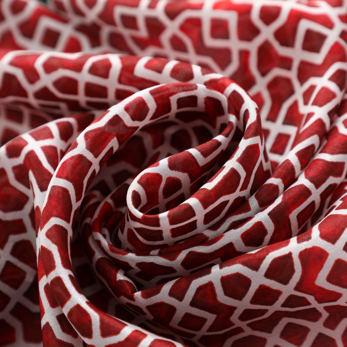 Red silk scarf with geometric print inspired by Andalusian tiles