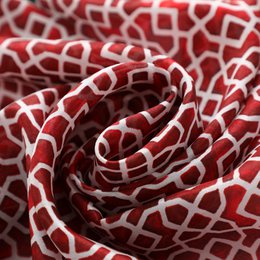 Red silk scarf with geometric print inspired by Andalusian tiles