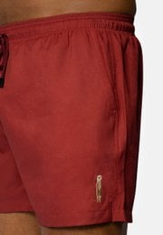 Red swim shorts with drawstring waist, suitable for men's swimwear.
