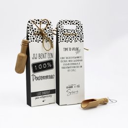 Bath salts in a polka dot package labeled "100% power woman"