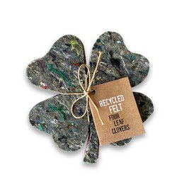 A box of recycled felt clover figures, a decorative trivet item. The product features a green box with the text "Box of Luck" and a shamrock-shaped felt figure inside.