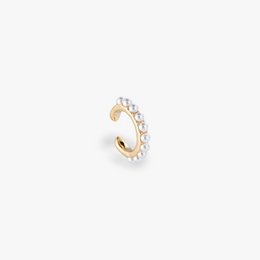 A gold-toned ear cuff featuring a row of pearls, creating a delicate and elegant accessory.