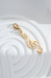 Charm clave de sol dorada en acero, clip musical, elegancia, pasión artística, chic