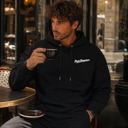 Black and green hoodie with Paris Departure text, vintage train aesthetic, comfortable casual style.