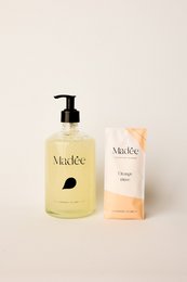 Glass hand soap set with orange scent, includes pump bottle and boxes.