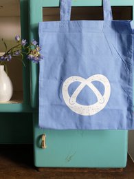 Sky blue fabric shopping bag with white pretzel motif