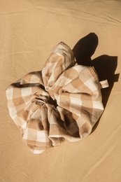 Large beige and white checkered scrunchie made of soft, textured fabric.