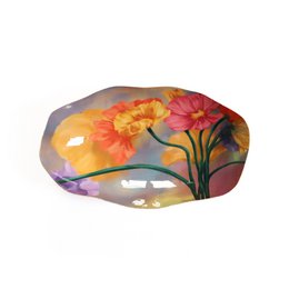 Decorative bowl with vibrant floral design in shades of orange, red, and yellow. Features a unique organic shape and textured surface.