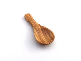 Small olive wood serving spoon, 6 cm long, with natural wood grain pattern.