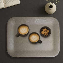 Small flat tray made of artificial brown leather with a stingray texture pattern.