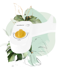 A white bidet with green leaves and a yellow accent, designed for personal hygiene in the bathroom.