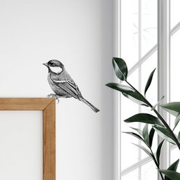 Black and white wall sticker of a great tit bird perched on a wooden frame.