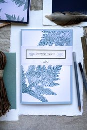 Blank notebook with fern-inspired grey-green cover and green framing.