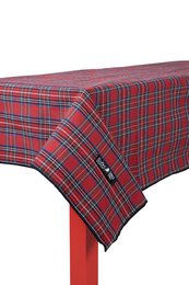  A red and black plaid tablecloth covering a wooden table, with a bowl of pomegranate seeds and other food items on the table.