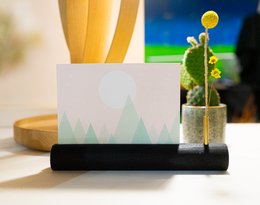 Black rectangular cardholder with minimalist mountain design. Made of durable material, suitable for storing cards and documents.