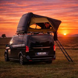 Black rigid roof tent, hard shell clamshell design, yellow interior, family size, car-mounted camping shelter.