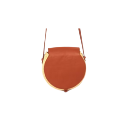 A round, orange shoulder bag with a gold-colored accent and adjustable leather straps.