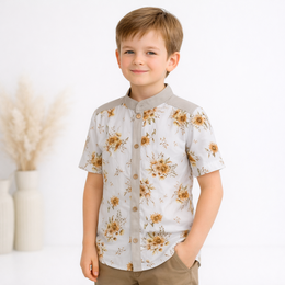 White short-sleeved kids' dress shirt with a floral print pattern featuring brown and yellow flowers.
